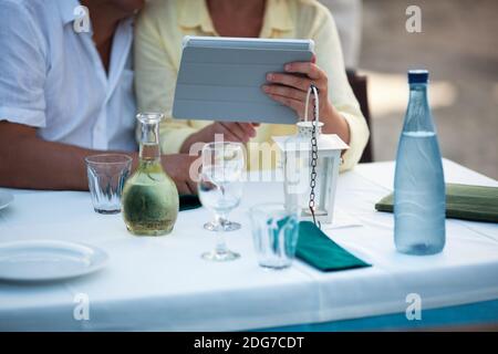 Middle-aged couple using a tablet at the table Stock Photo