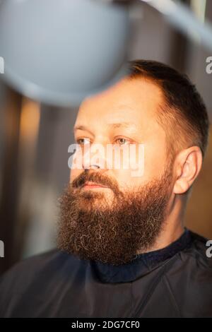 Attractive bearded man in a barber shop Stock Photo