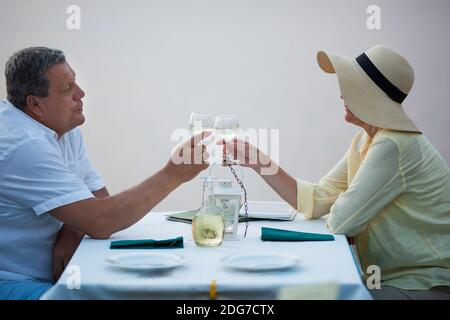 Romantic middle-aged couple toasting each other Stock Photo