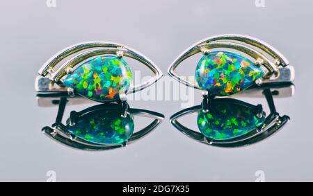 Silver earrings in the shape of human eyes with multi-colored stones Stock Photo