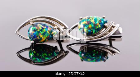 Silver earrings in the shape of human eyes with multi-colored stones Stock Photo