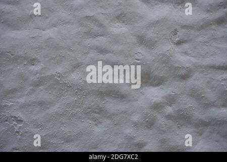 texture of relief surface of cement or concrete. Rough white relief stucco wall texture background. blank for designers. grey concrete background. Stock Photo
