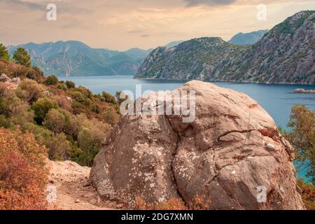 Beautiful idyllic mountain landscape sea. Amazing mountain landscape on the cloudy sky, natural outdoor travel background. large rock boulder in the f Stock Photo