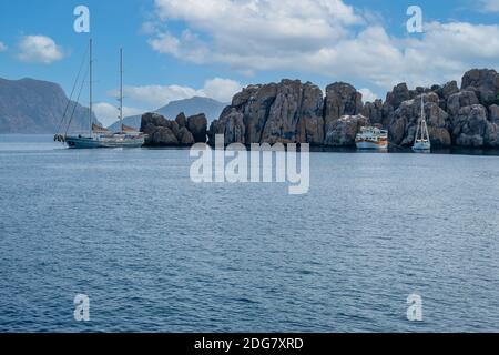 luxury sailing ship, two masts, docked anchored in tropical exotic island with turquoise sea. beautiful seascape with yachts and sailing ships. holida Stock Photo