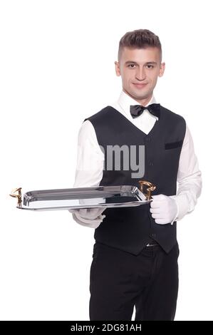 Portrait of young happy smiling waiter with on tray isolated on white background Stock Photo
