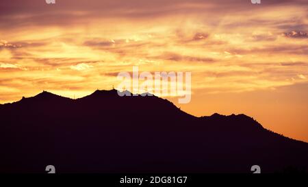 Colorful sunset in East San Francisco Bay Area, with brightly colored clouds covering Mt Diablo summit; Contra Costa County, California Stock Photo