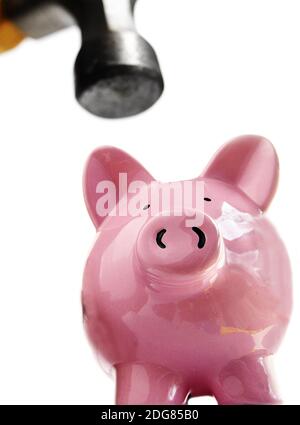 Rompere un salvadanaio con un martello - Break a money box or a piggy bank  with a hammer Stock Photo