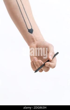 Hand with black pencil Stock Photo