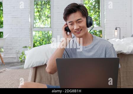 Wearing headphones to listen to music of young men Stock Photo
