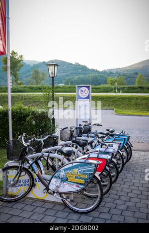 Nextbike bicycles locked up at a rental station in a town along the Danube river in Austria on a spring day. Stock Photo