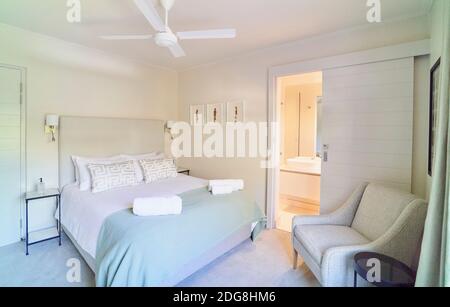 Tranquil home showcase interior bedroom with en suite bathroom Stock Photo