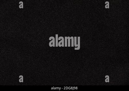 Structure of black fabric as pattern backdrop. Dark grey background from textile material with wicker texture. Stock Photo