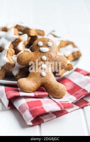 Xmas gingerbread man on checkered napkin. Stock Photo