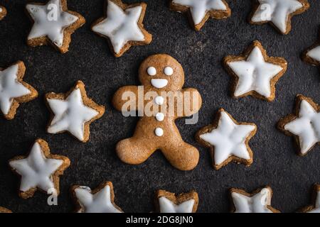 Xmas gingerbread man on black table. Top view. Stock Photo