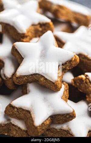 Icing gingerbread stars. Traditional Christmas cookies. Stock Photo