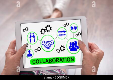 Collaboration concept shown on a tablet held by a woman Stock Photo