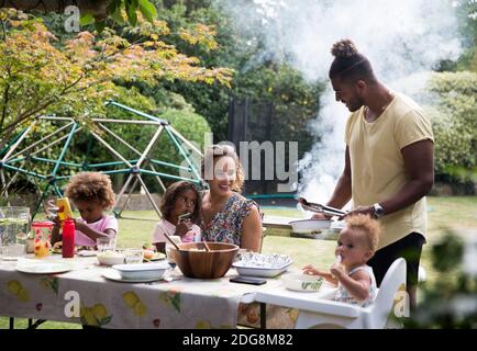 Happy family enjoying summer barbecue at patio table Stock Photo