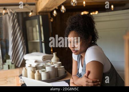 Female shop owner using digital tablet at shop counter Stock Photo
