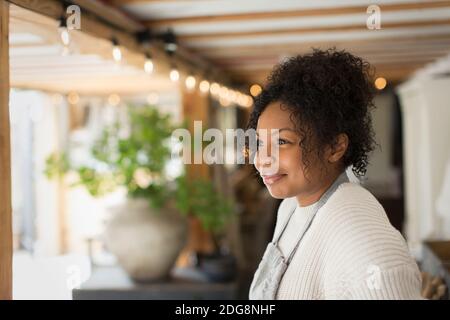 Smiling female shop owner looking away Stock Photo