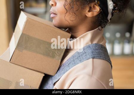 Close up female shop owner with cardboard boxes Stock Photo