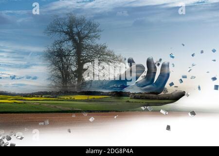 Digital hand over rural landscape Stock Photo