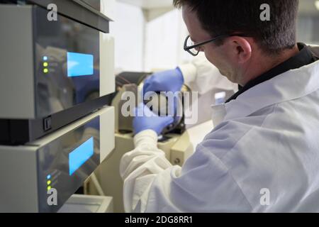 Male scientist using equipment in laboratory Stock Photo