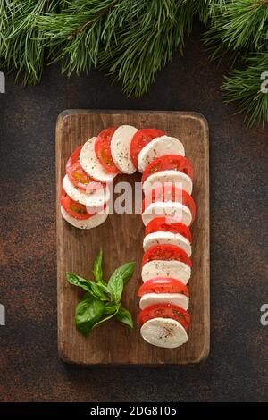 Caprese candy cane board is holiday appetizer for festive Xmas party. View from above. Stock Photo