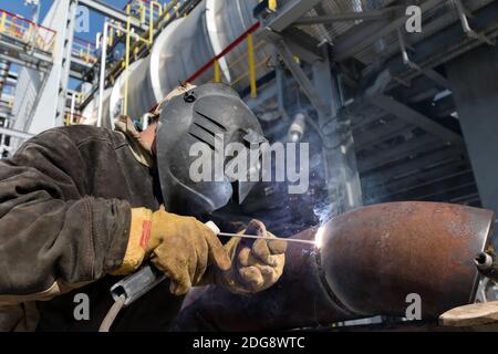 Welding works on metal  heat exchanger using manual arc welding Stock Photo