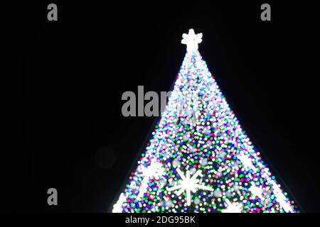 Abstract background with colorful bokeh lights, winter Christmas tree background with sparkling stars Stock Photo