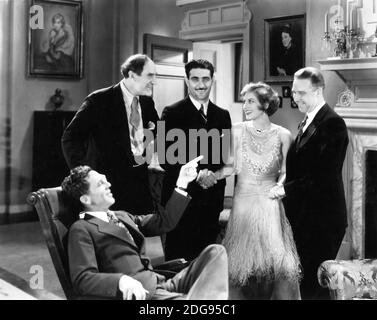 Director JACK CONWAY (seated) ERNEST TORRENCE and JOAN CRAWFORD with Set Visitors Endurance / Marathon Flyers LOREN W. MENDELL and PETE REINHART on set candid during filming of UNTAMED 1929 director JACK CONWAY Metro Goldwyn Mayer Stock Photo