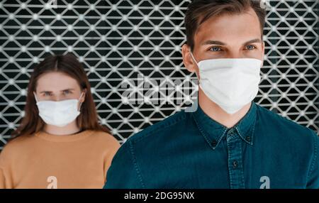 close up. a man and a woman in protective masks standing next to each other . Stock Photo