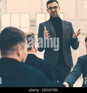 smiling employees shaking hands during a working meeting Stock Photo