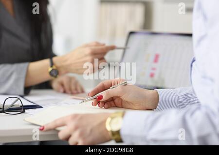 Two colleagues discussing commercial metrics of business on tablet. Stock Photo