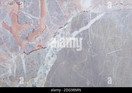 Variegated stone with grey, white and colors texture background with scratches Stock Photo