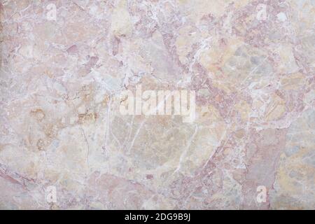 Variegated rough stone with grey, pink, and beige colors texture background Stock Photo