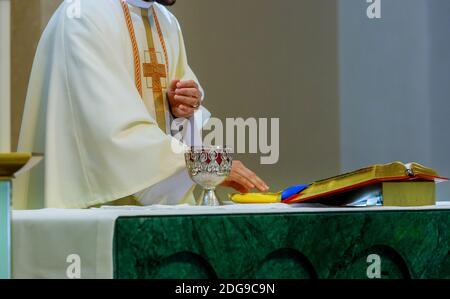 Holy communion on table in church and Holy Bible cup of glass with red wine Stock Photo