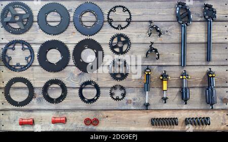 Components and spare parts for the bike on a wooden bench in the shop Stock Photo