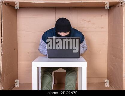 hard work of a hacker on a computer in his secret office Stock Photo