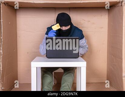 the criminal holds a credit card in his hand Stock Photo