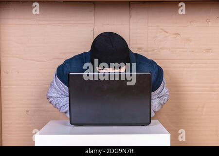 hard work of a hacker on a computer in his secret office, close up Stock Photo