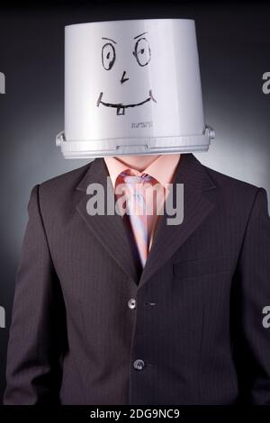 funny businessman with a bucket on his head Stock Photo