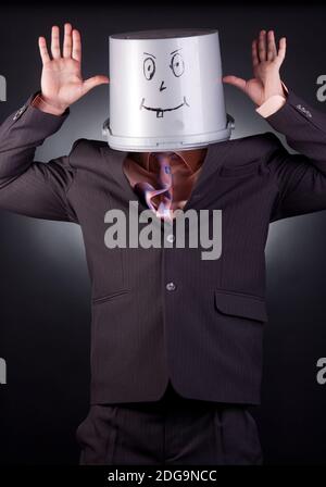 funny businessman with a bucket on his head Stock Photo