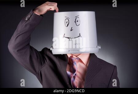 funny businessman with a bucket on his head Stock Photo