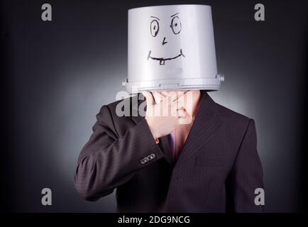 funny businessman with a bucket on his head Stock Photo