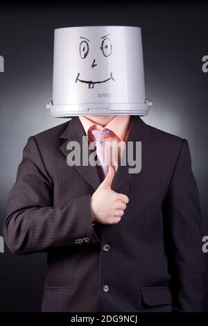 funny businessman with a bucket on his head Stock Photo