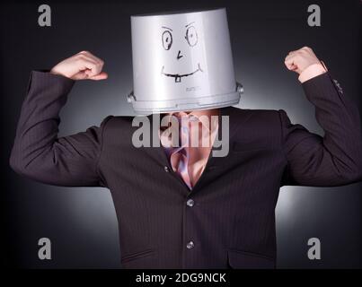 funny businessman with a bucket on his head Stock Photo