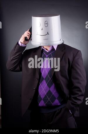 funny businessman with a bucket on his head Stock Photo