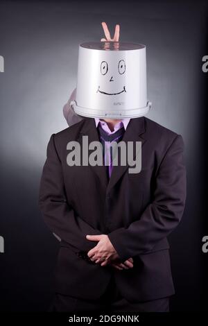 funny businessman with a bucket on his head Stock Photo