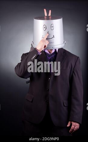 funny businessman with a bucket on his head Stock Photo