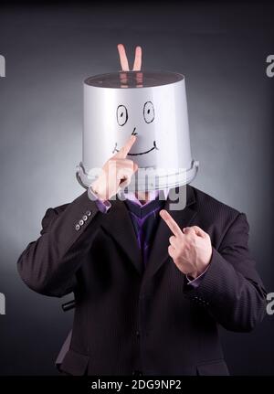 funny businessman with a bucket on his head Stock Photo